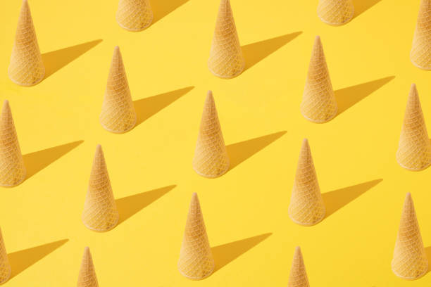 istock Summer pattern with ice cream cones turned upside down on yellow background. Minimal concept. 1397409461