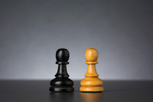 Black and white chess pawns as a contrast concept