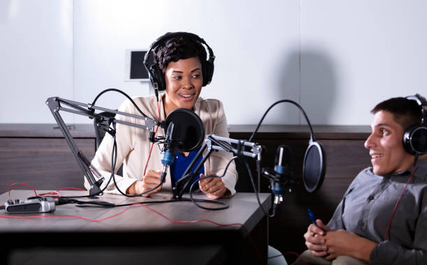 istock Female podcast host interviewing man in wheelchair 1397410380