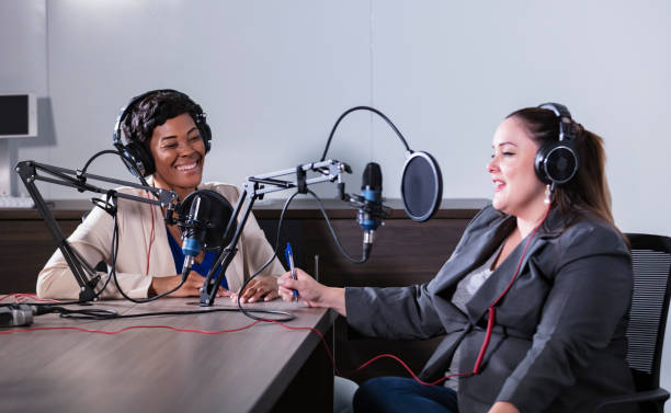 istock Two multiracial women recording a podcast 1397410397