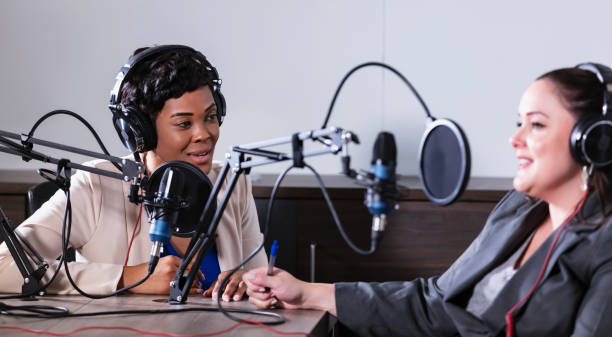 istock Two multiracial women recording a podcast 1397410408