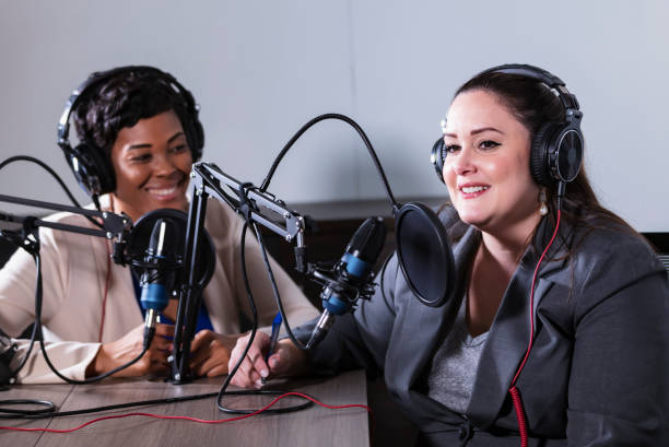 istock Two multiracial women recording a podcast 1397410425