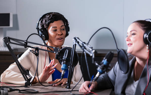 istock Two multiracial women recording a podcast 1397410438