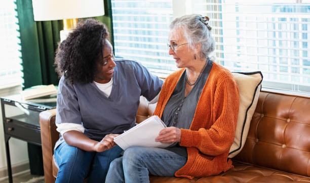 istock Senior woman taking notes, talks with home caregiver 1397411502