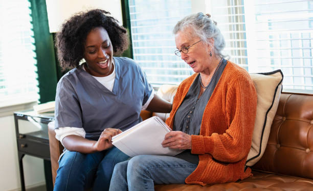 istock Senior woman taking notes, talks with home caregiver 1397411525