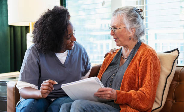 istock Senior woman taking notes, talks with home caregiver 1397411536
