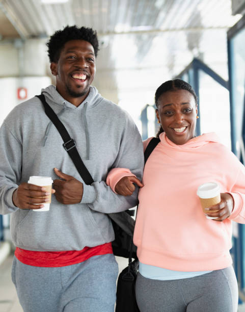 istock African-American couple on train platform with coffee 1397411543