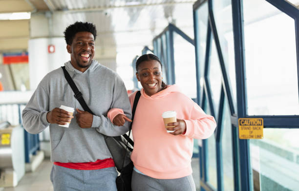istock African-American couple on train platform with coffee 1397411544