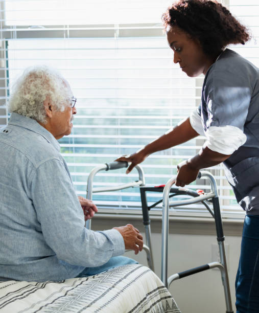 istock Home healthcare worker helps senior man with walker 1397412321