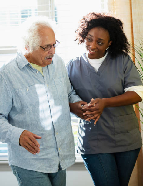 istock Home healthcare worker helps senior man walk 1397412337