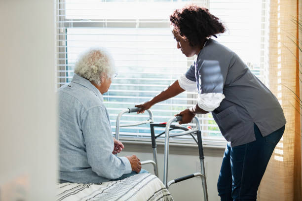 istock Home healthcare worker helps senior man with walker 1397412355