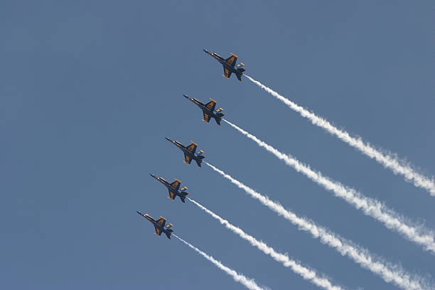 Five jets flying in formation across the blue sky stock photo