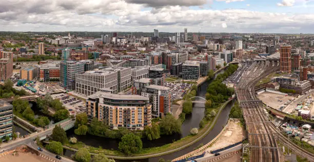 An aerial cityscape of Leeds city centre including the Leeds to Liverpool canal and train station from Whitehall business district