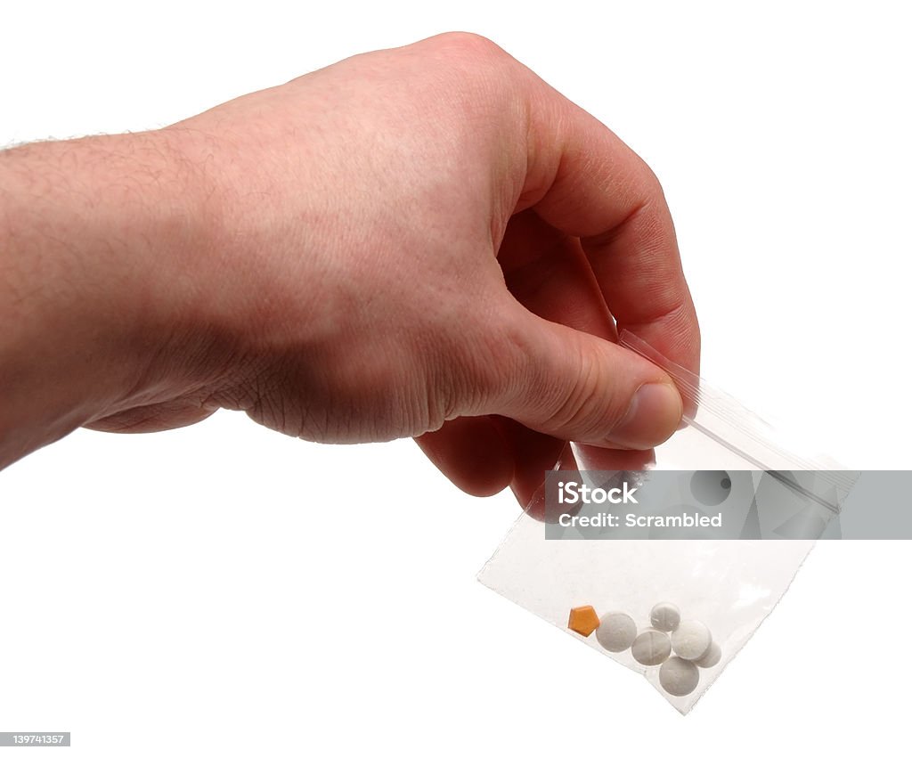 Drug packet Hand holding a packet of 3 types of pill, isolated on a white background. MDMA Stock Photo