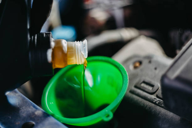 istock pouring new engine oil into the engine 1397413590