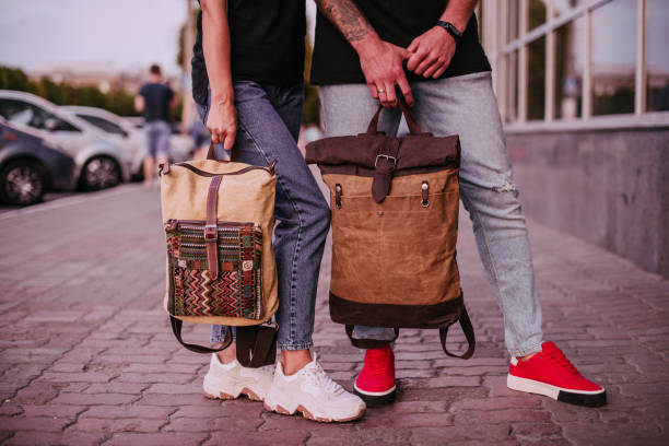 istock Woman and man holding in hands canvas backpacks 1397413650