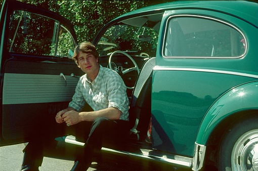 Lower Saxony, Germany, 1968. A young man and his first car on a trip to the country.