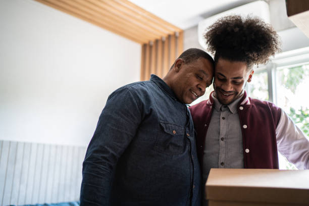 istock Father helping son packing to move out from parent's home 1397414962