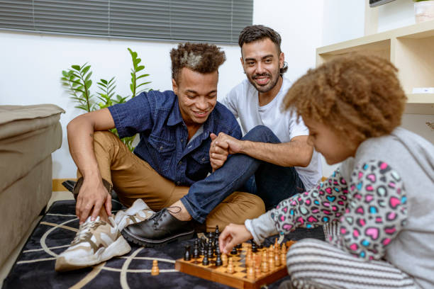 istock Couple with daughter playing chess at home 1397415006