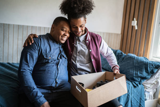 Father helping son packing to move out from parent's home