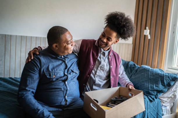 istock Father helping son packing to move out from parent's home 1397415623