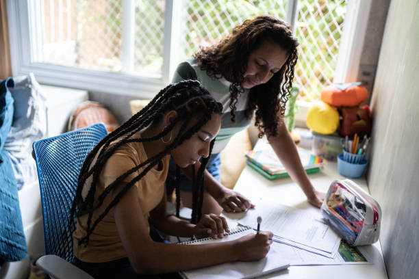 istock Mother helping daughter studying at home 1397416387