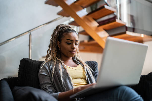 istock Young woman using the laptop at home 1397416553