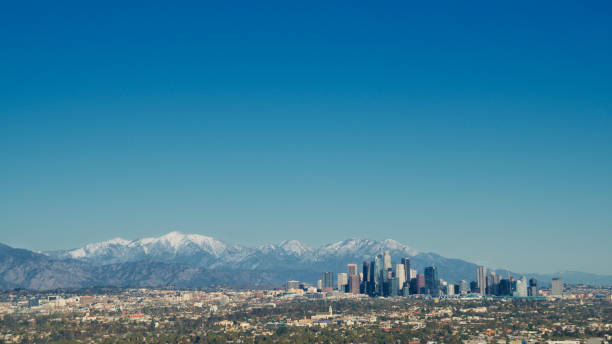 istock Los Angeles skyline framed by snowcapped mountains - panorama 1397417418