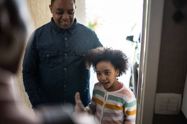 istock Father and daughter being greeted by real estate agent 1397417740