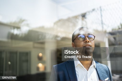 istock Businessman looking out of window 1397417789