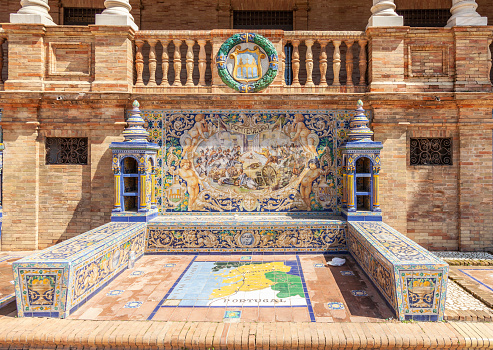 Seville, Spain - 7th April 2022   Tiled alcove and bench representing the Spanish province of Pontevedra, in the Plaza de España in central Seville, Andalucia, Spain. The Defence of Pontevedra is illustrated.