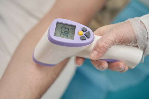 istock Doctor taking patient temperature in clinic office 1397420647