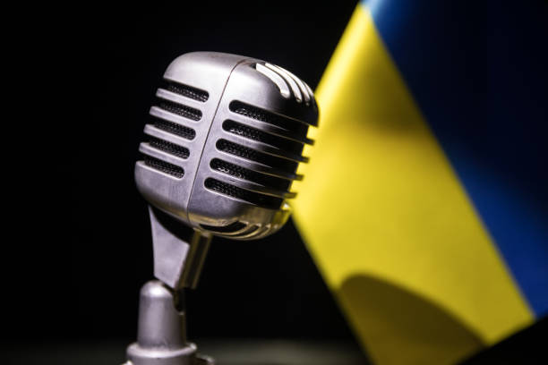 istock Microphone on a background of a blurry flag Ukraine close-up 1397420831