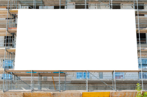 istock Blank white afvertising banner mounted on the scaffoldings 1397421390