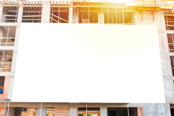 istock Advertising banner mock-up mounted on a fall of building under construction 1397421424