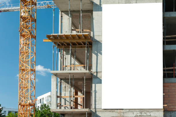 istock Advertising banner mock-up on the wall of building under construction 1397421441