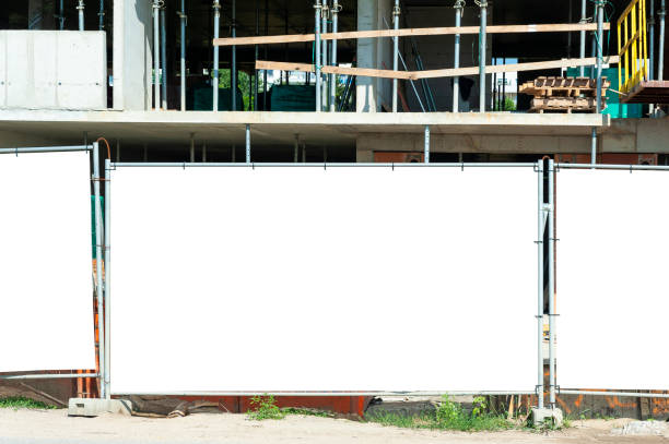 istock Blank white banner for advertisement mounted on the hoardin of construction site 1397421514