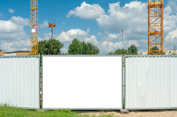 istock Blank white banner for advertisement mounted on the hoardin of construction site 1397421555