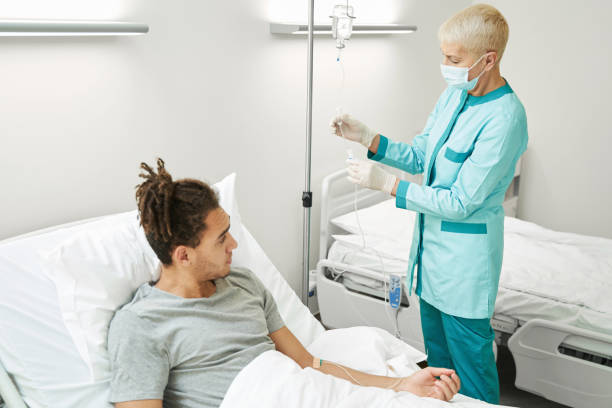istock Woman medic regulating IV line with drip chamber 1397422807