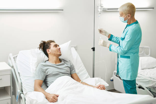 istock Medical professional using drip chamber of intravenous line 1397422809