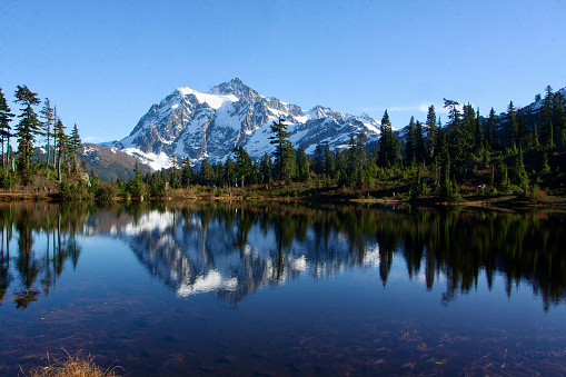 This is a panoramic shot showing Mount Timpanogos in Utah's Wasatch Mountains range.  Mt. Timpanogos is a tall landmark in Utah County, ajoining many of the cities including Provo.  This shot was taken during a wet spring season with the base of the mountain looking very green and the peak covered in snow.