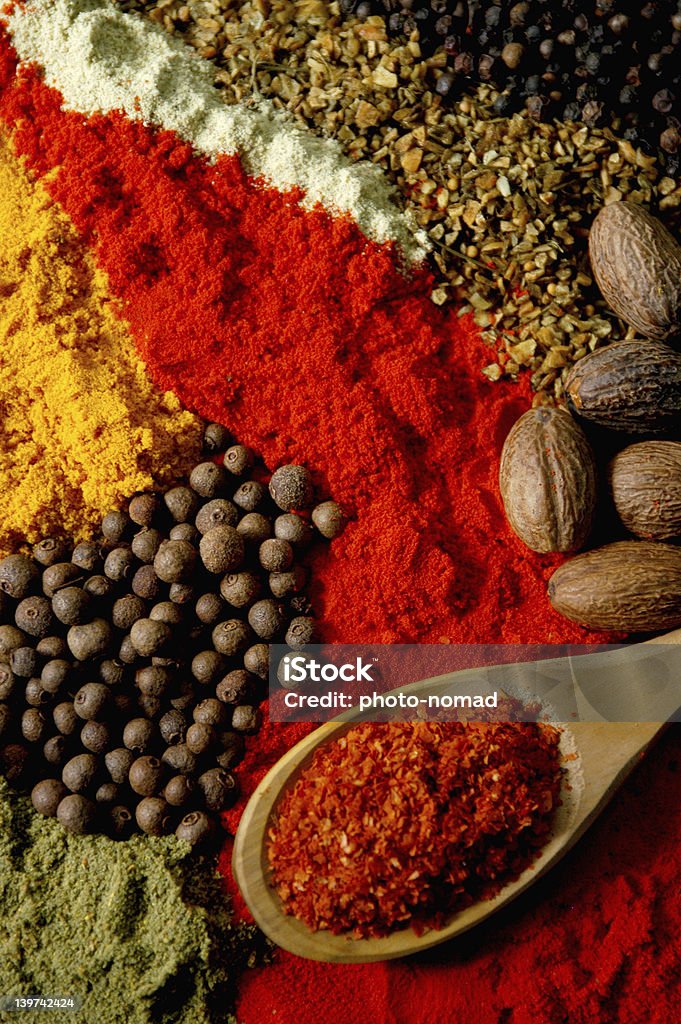 Close-up still life photo of various spices A variety of spices arranged with a wooden spoon Brown Stock Photo