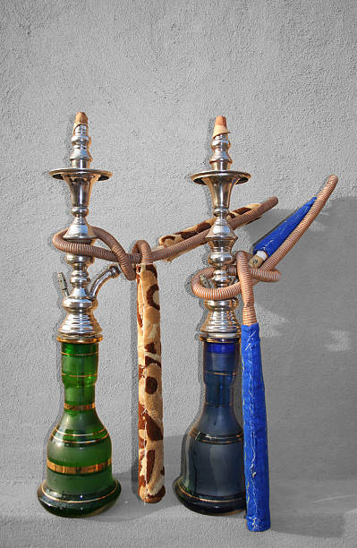 Shisha Pair - Desaturated Two Arabic Shisha pipes sitting on a sandstone wall hubblybubbly stock pictures, royalty-free photos & images
