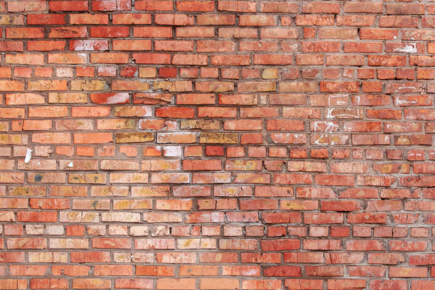 istock Antique red brick wall with age damage. 1397427678