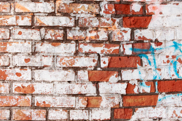 istock Antique red brick wall with age damage. 1397427760