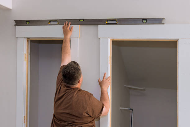 istock Carpenter at checks level correctness installation door 1397428778