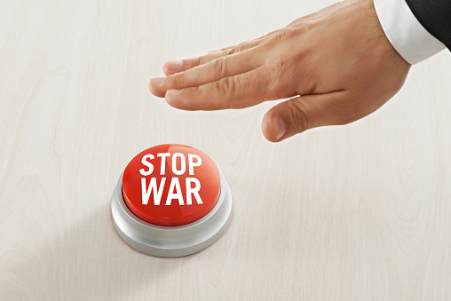 Businessman pushing “Stop the War” ubutton