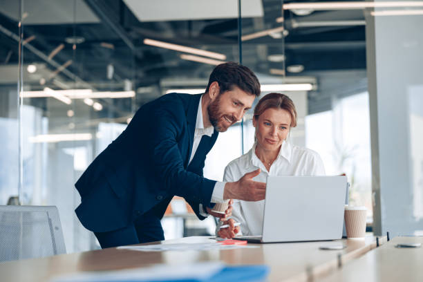istock Mature female boss discussing online project with employee 1397430056