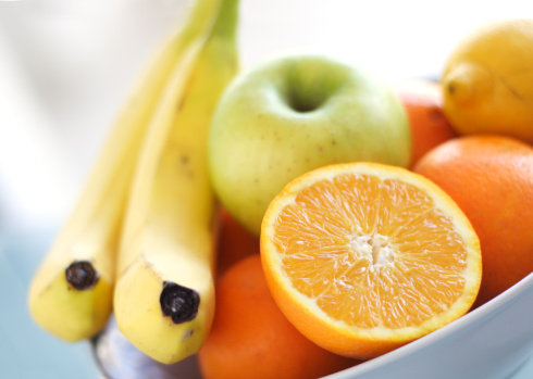 bowl of mixed fruits in bright colors, shallow dof