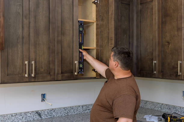 istock Carpenter at checks level correctness installation custom kitchen cabinet 1397432266